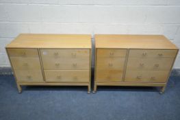 A PAIR OF MID CENTURY LIGHT OAK STAG CHEST OF SIX ASSORTED DRAWERS, on plastic casters, width 97cm x