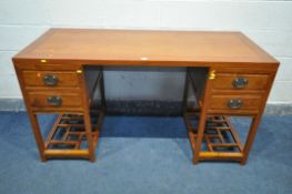 AN ORIENTAL QING DYNASTY STYLE HARDWOOD PEDESTAL DESK, with four drawers, on a base width 155cm x