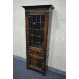 AN EARLY 20TH CENTURY OAK LEAD GLAZED SINGLE DOOR BOOKCASE, enclosing three adjustable shelves,