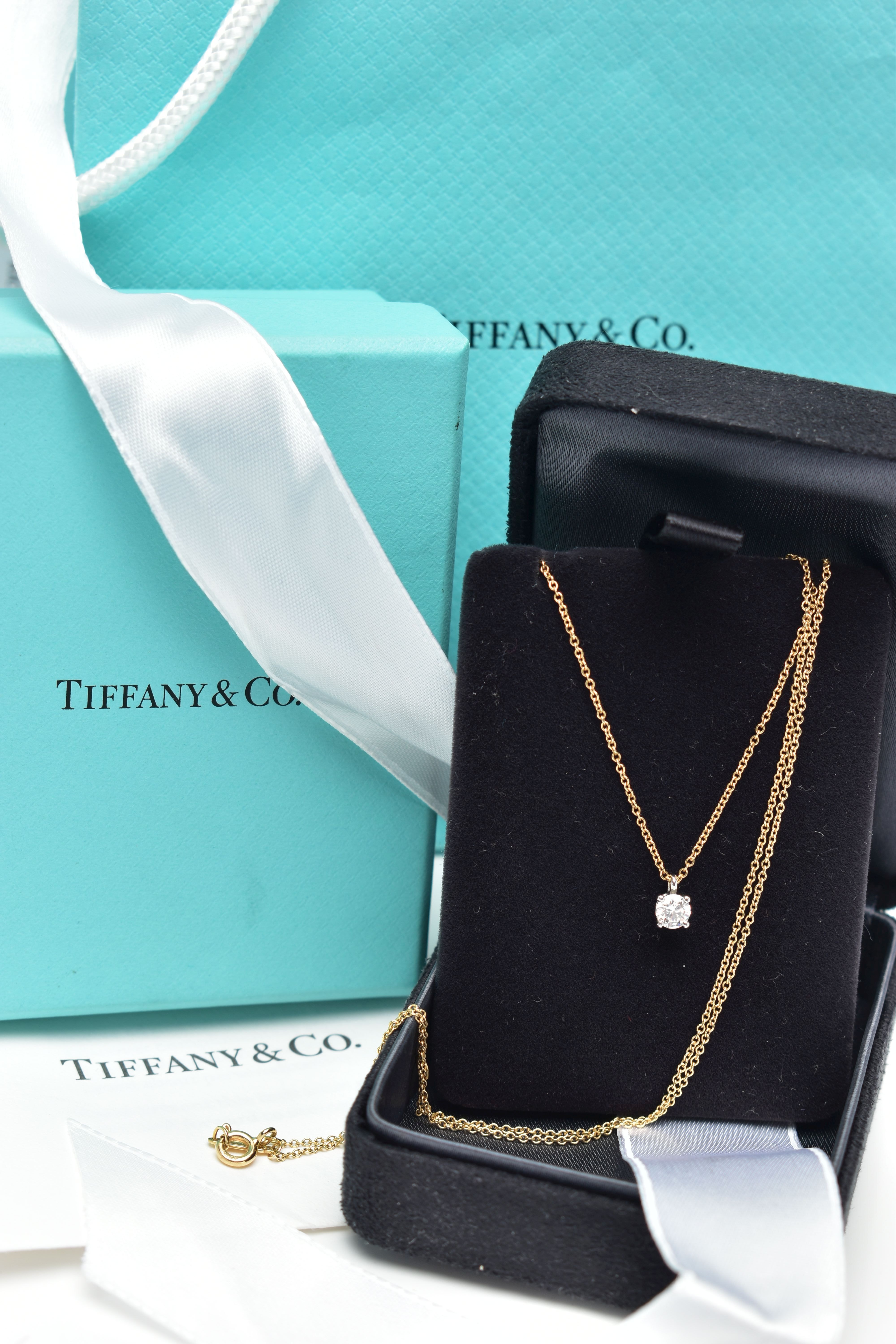 AN 18CT YELLOW AND WHITE GOLD TIFFANY & CO DIAMOND PENDANT NECKLACE, set with a round brilliant