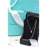 AN 18CT YELLOW AND WHITE GOLD TIFFANY & CO DIAMOND PENDANT NECKLACE, set with a round brilliant