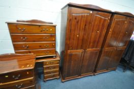 A STAINED PINE BEDROOM SUITE, comprising two double door wardrobes, width 104cm x depth 56cm x