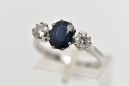 AN 18CT WHITE GOLD SAPPHIRE AND DIAMOND THREE STONE RING, centering on an oval cut deep blue