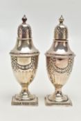 A PAIR OF SILVER PEPPERETTES, each of an urn form, decorated with a bow and swag design with stop