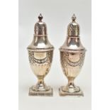 A PAIR OF SILVER PEPPERETTES, each of an urn form, decorated with a bow and swag design with stop