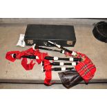 A SET OF MODERN BAGPIPES with ebonised wood and plastic rings, red ribbon and tartan covering a