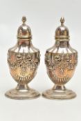 A PAIR OF SILVER PEPPERETTES, decorated with an embossed floral, bow and swag design, on oval bases,