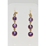 A PAIR OF YELLOW METAL AMETHYST DROP EARRINGS, each earring set with three circular cut amethysts,