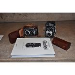 A ROLLEICORD IV K3D TLR CAMERA with a Heidosmat 75mm f3.2 and Xenar 75mm f3.5 lenses in leather