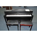 A YAMAHA CLAVINOVA CLP545 DIGITAL ELECTRIC PIANO in matt black finish with manual, a matching