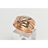A 9CT COILED SNAKE RING, wide band of a coiled snake, the head is set with five graduated round