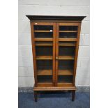 AN EARLY 20TH CENTURY OAK GLAZED TWO DOOR BOOKCASE, on square tapered legs, width 83cm x depth