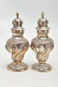 A PAIR OF SILVER PEPPERETTES, each of a baluster form, embossed floral pattern, on round bases,