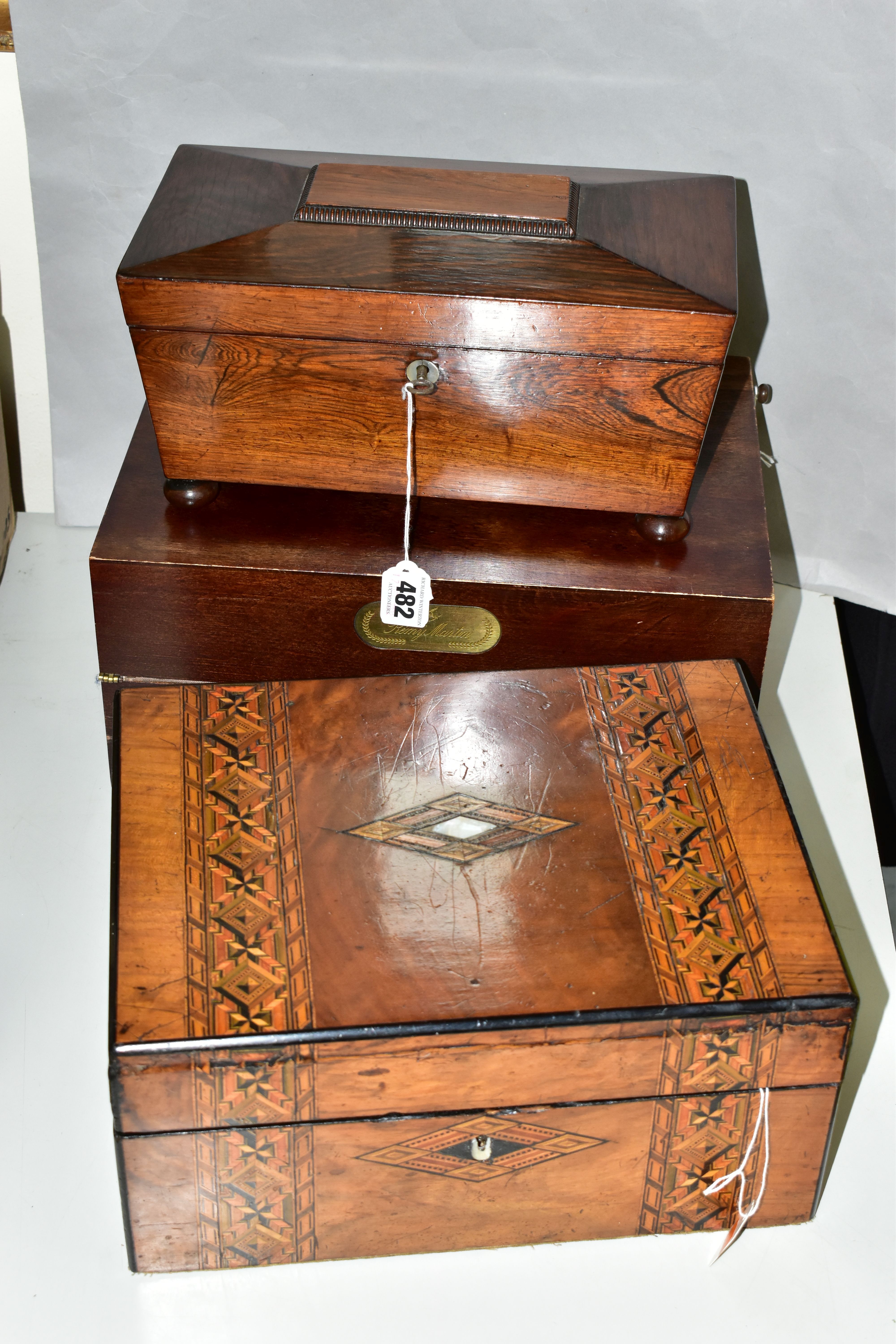 A REGENCY ROSEWOOD TEA CADDY AND TWO WRITING SLOPES, the tea caddy of sarcophagus form supported