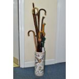 A STICK STAND OF WALKING STICKS AND UMBRELLAS, to include a Knobkerrie length 77.5cm (splits to