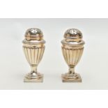 A PAIR OF VICTORIAN SILVER PEPPERETTES, each of a tapering form, stop reeded design, on weighted