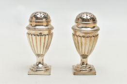 A PAIR OF VICTORIAN SILVER PEPPERETTES, each of a tapering form, stop reeded design, on weighted