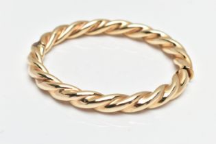 A MODERN 9CT YELLOW GOLD HINGED BANGLE, designed as a plain polished twist, with concealed push