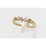 A 9CT GOLD DIAMOND RING, designed as a wavy half eternity ring, set with five round brilliant cut