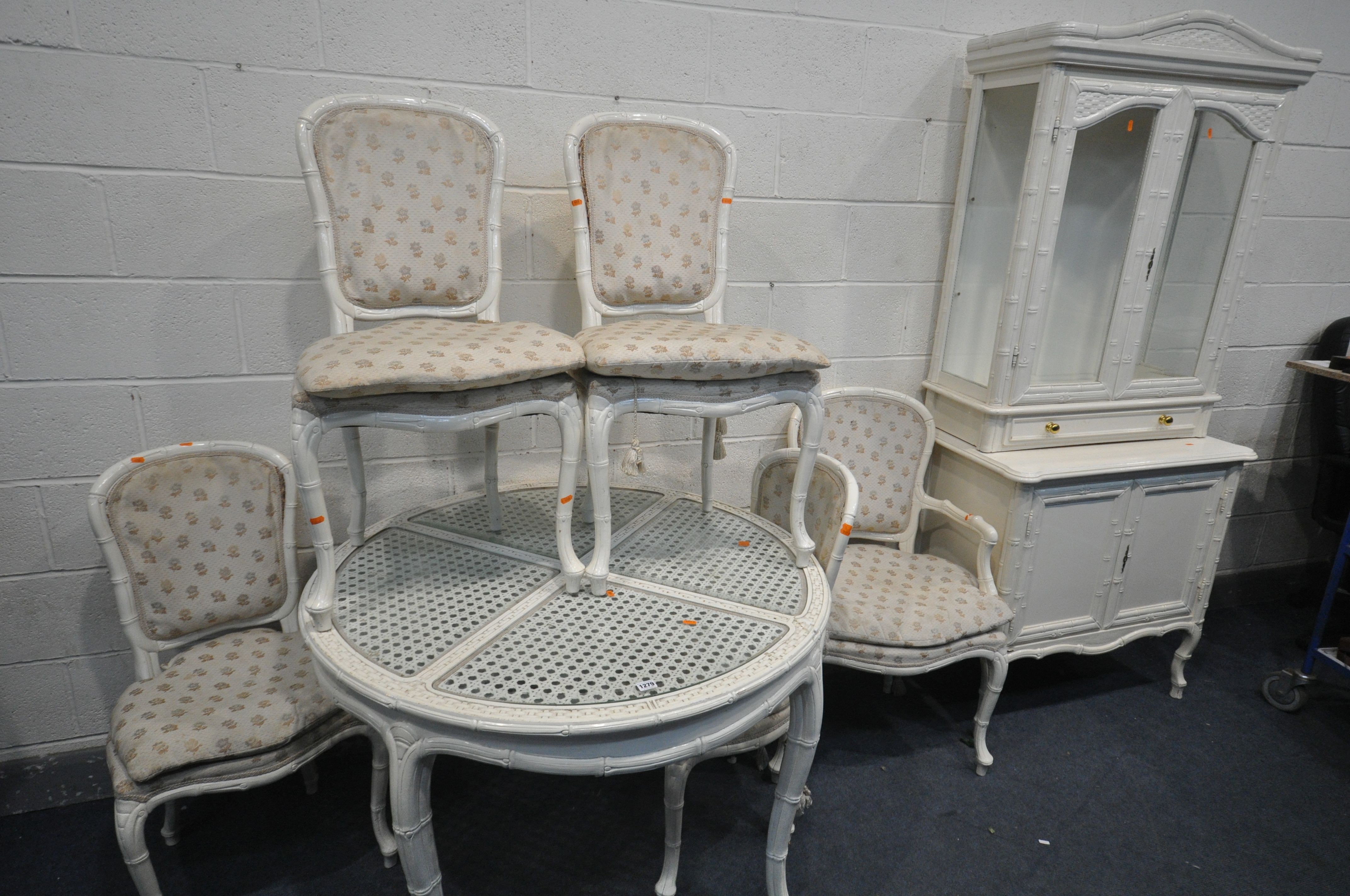 A CREAM FRENCH BAMBOO STYLE DINING SUITE, comprising a circular table, with glass inserts,