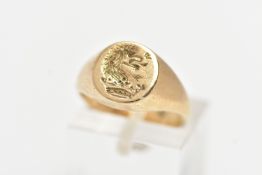 A 9CT YELLOW GOLD INTAGLIO SIGNET RING, of an oval form, engraved intaglio to the centre, to a
