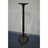 A MAHOGANY TORCHERE STAND, on a circular base with floral base, and triple claw legs, height