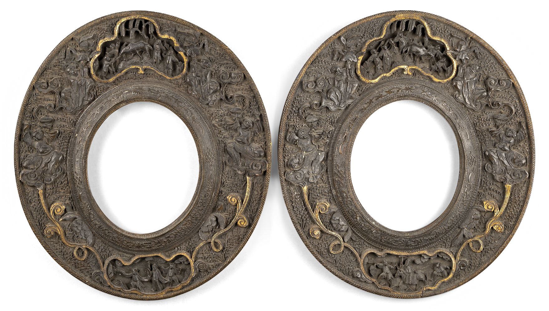 A pair of Chinese carved wood oval frames, 19th century, each with panels depicting various