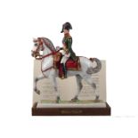 A Van Gerdinge / Sitzendorf porcelain figure group of the Emperor Napoleon I on horseback in 1805