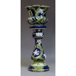 A Minton-style Majolica jardinière and stand, 19th century, with moulded flora decoration, the stand