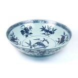 A large Chinese blue and white bowl, 20th century, decorated to interior with a bird eating