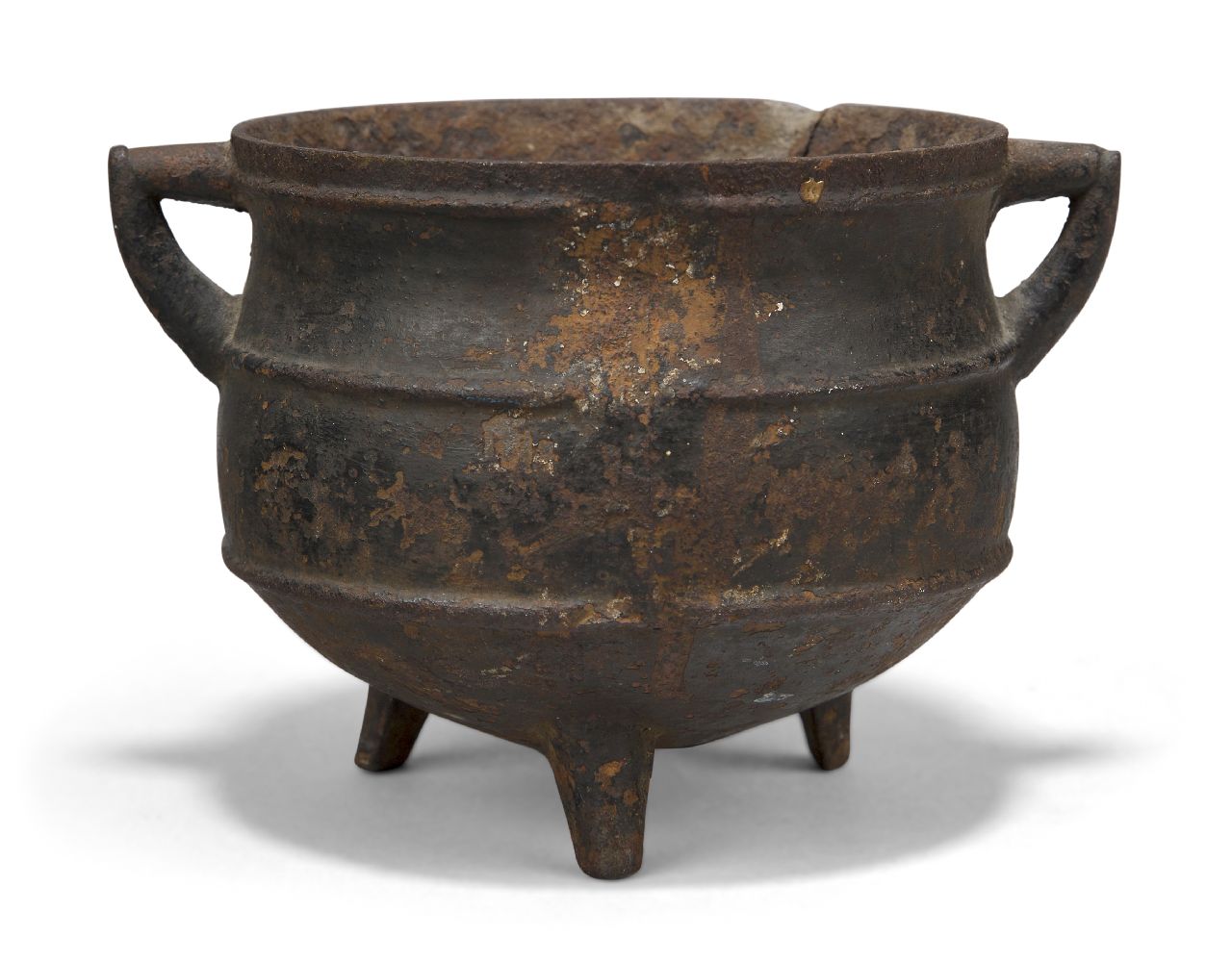 A Chinese iron cauldron form censer, 16th century, with two angular handles, the body decorated with