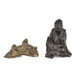 A Chinese Ming-style gilt bronze scroll weight and a bronze finial, Ming and early 20th dynasty, the