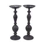 A pair of Chinese bronzed metal candlesticks, 20th century, with knopped stems on spreading bases