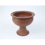 A large Roman style goblet vase, of recent manufacture, in terracotta on footed base, 24.5cm