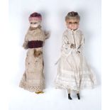 Two wax over composition dolls, both with moulded hats on cloth covered bodies with carved lower