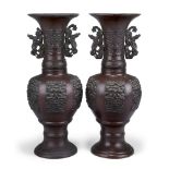 A pair of Japanese bronze vases, early 20th century, decorated with panels of dragons, 37cm