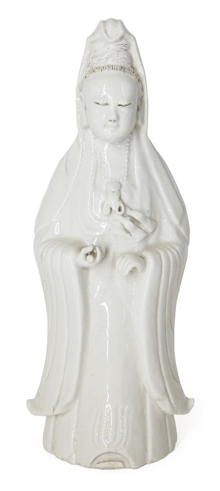 A Chinese Dehua porcelain figure of Guanyin, 19th century, modelled standing with long flowing