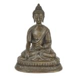 A Tibetan bronze figure of Shakyamuni Buddha, 19th century, cast seated in dhyanasana on a double-
