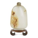 A Chinese pale green and russet jade 'pebble' snuff bottle, 18th/19th century, of irregular form