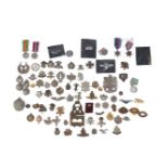 A quantity of mainly WWI and WWII British and Commonwealth military cap badges, medals and foreign