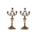 A pair of gilt bronze and onyx three light candelabera, 19th Century, the openwork bronze mounts