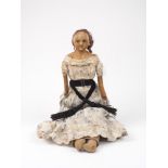 A wax over composition slit-head doll, on cloth body with leather lower arms, wearing original