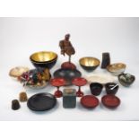 A group of Oriental lacquer items, 20th century, comprising: two trays, three stands, a large red