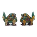 A pair of Chinese porcelain lion dog censers with covers, Ming style, in brown yellow and green