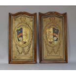 A pair of painted armorial panels, 20th century, on wood, each with a shield centred in a