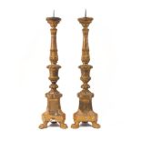 A pair of continental gilt wood altar pricket candlesticks, early 20th century, with triform bases