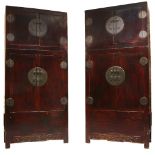 A pair of Chinese lacquered softwood cabinets, late Qing dynasty, each with hat box above pair of