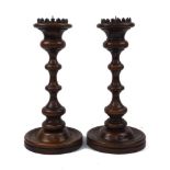 A pair of large turned beech candlesticks, late 20th century, each with bronze pricket and waisted