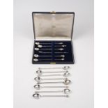 A cased set of six Brazilian spoons with novelty terminals, stamped 900, designed with twisted