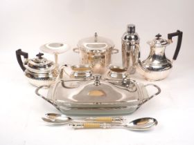 A group of silver plate including: a small novelty flute; an ice bucket, a cocktail shaker, a four